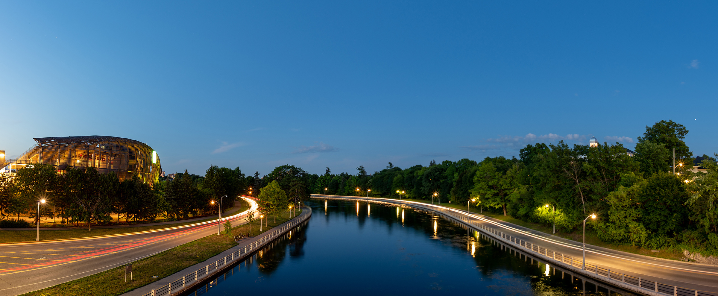 Rideau canal blue hour from Bank Street Bridge with TD Place in and Queen Elizabeth Drive