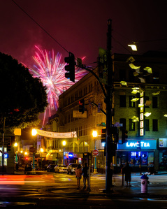 Fireworks explode over San Francisco's Chinatown as seen from Columbus Avenue in North Beach.