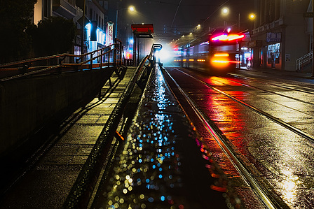 The N Judah streetcar heads off, leaving only reflections in a rain-soaked San Francisco street in the Inner Sunset neighborhood.