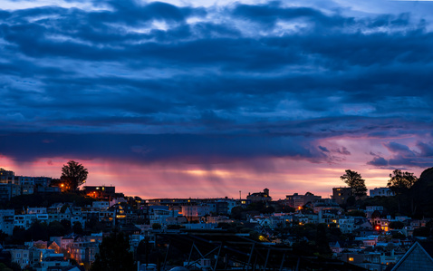 The sun rises through storm clouds over San Francisco&#x27;s Cole Valley and Ashbury Heights neighborhoods