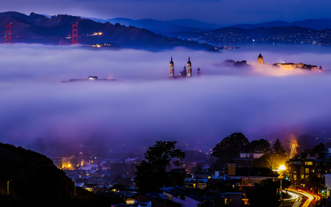 The University of San Francisco&amp;amp;amp;#x27;s St. Ignatius church, the Golden Gate Bridge, and Golden Gate Park covered in low fog