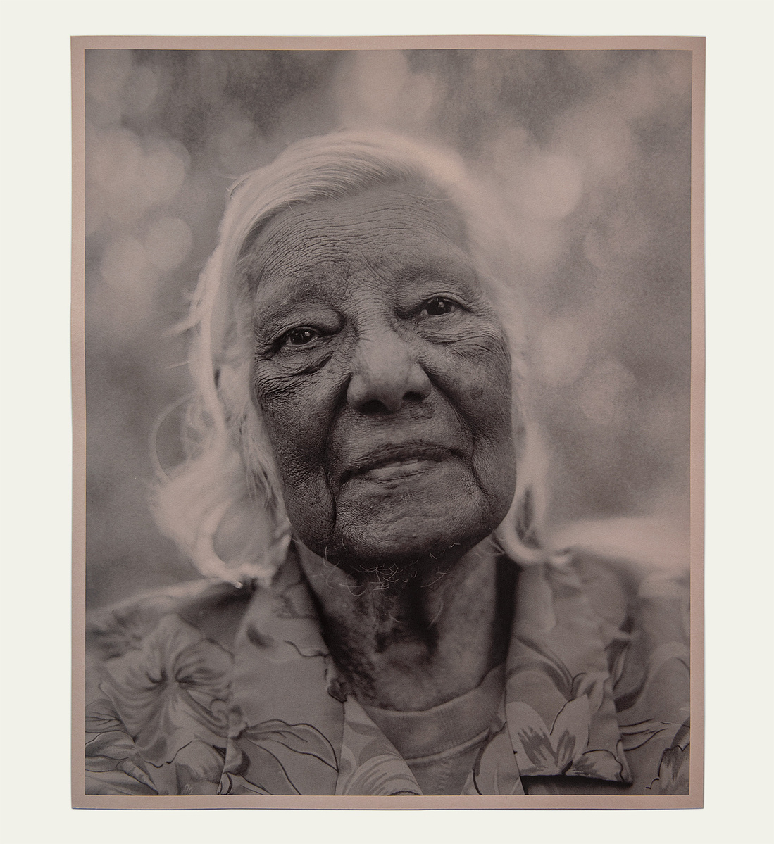 monotone portrait of elder Australian indigenous woman, head and shoulders, wizened face, soft look