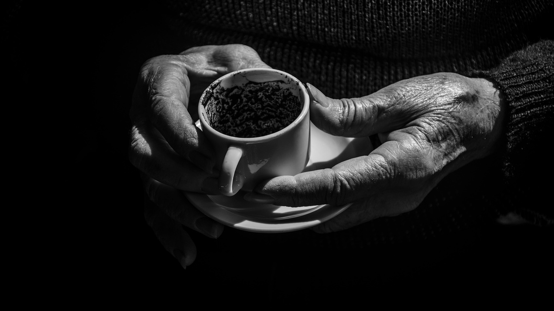 Untitled 8, still from the reading with the readers hands around the cup.