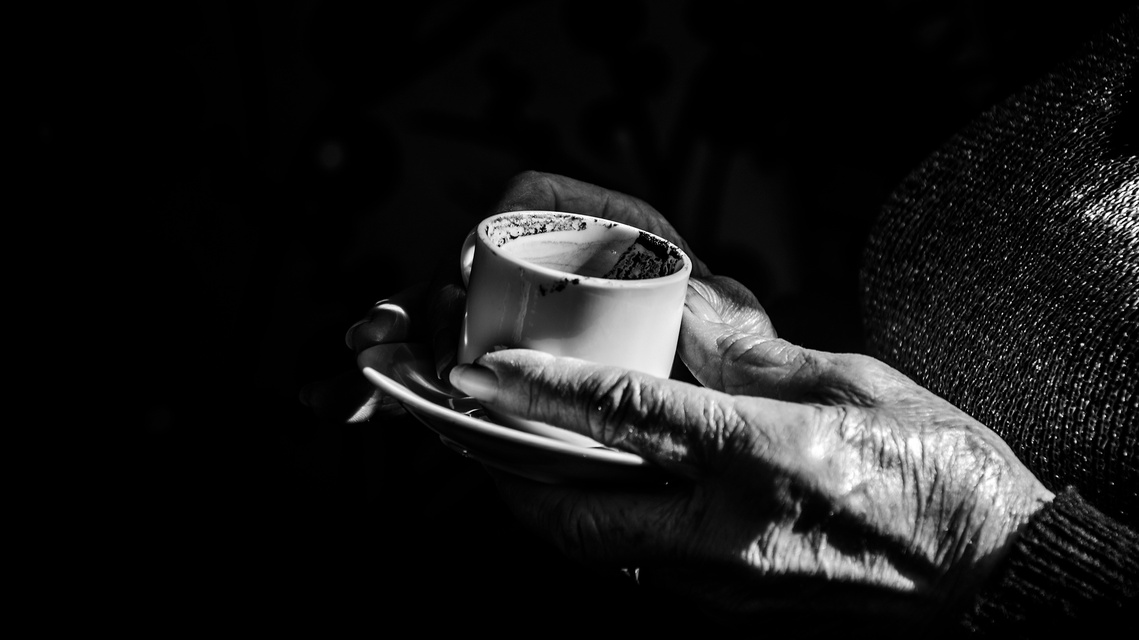 Untitled 2, still from the reading with the readers hands around the cup.