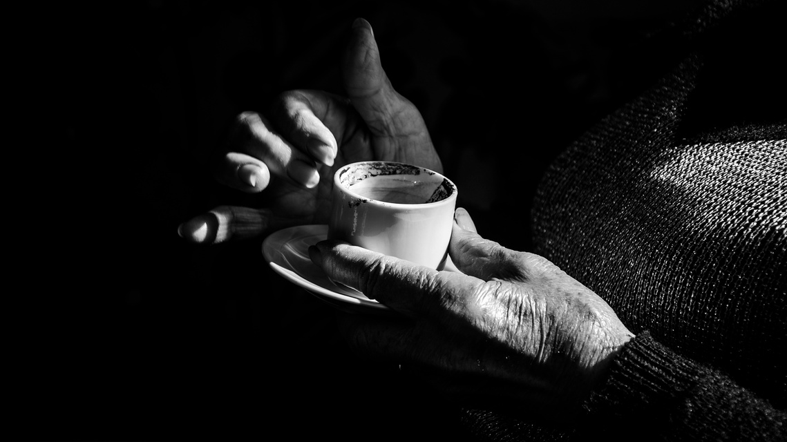 Untitled 3, still from the reading with the readers hands around the cup.