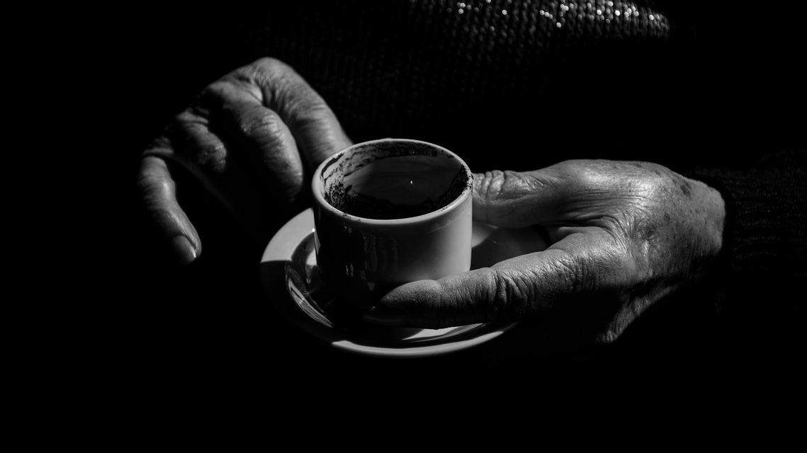 Untitled 10, still from the reading with the readers hands around the cup.