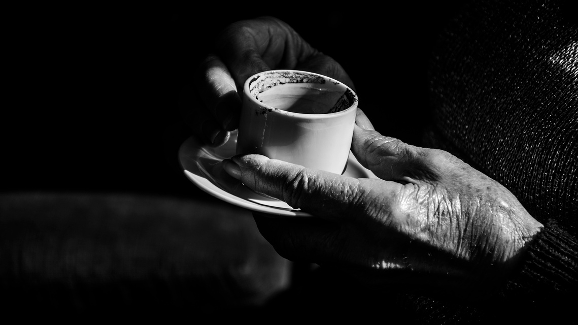 Untitled 4, still from the reading with the readers hands around the cup.