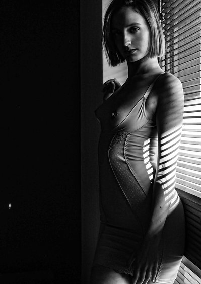  A  woman wearing  lingerie during a boudoir photo session advertising underwear  
