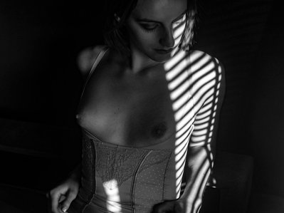 A classy black and white photo with a woman posing in her lingerie during her boudoir photoshoot 