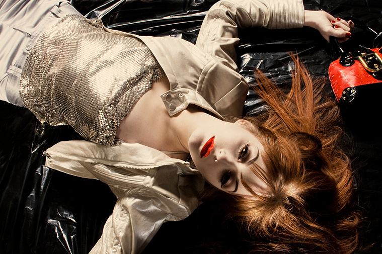 Female protagonist dressed to party perhaps dead red lips red bag