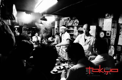 A smoky yakitori restaurant in an alleyway in Shinjuku Tokyo Japan.