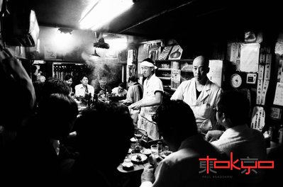 A smoky yakitori restaurant in an alleyway in Shinjuku Tokyo Japan.