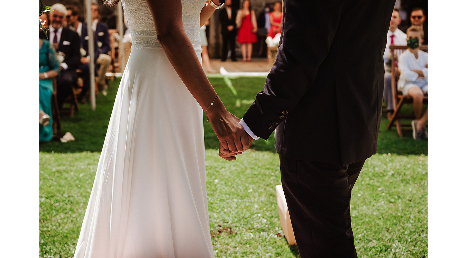 Novios cogidos de la mano durante la ceremonia civil al aire libre