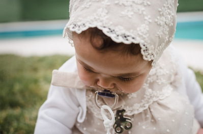 Reportaje fotográfico de bautizo. Fotos niña pequeña con traje de bautizo