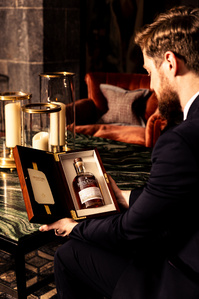 Midleton Very Rare Whiskey collaboration with Adare Manor Limerick. Head bartender at Adare Manor Tommie with the boxed whiskey. Drinks photography Limerick.