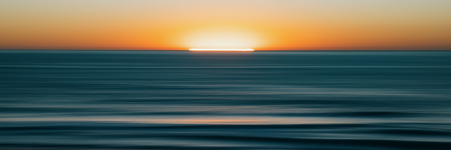 A panoramic view of sunset over the Pacific Ocean. 