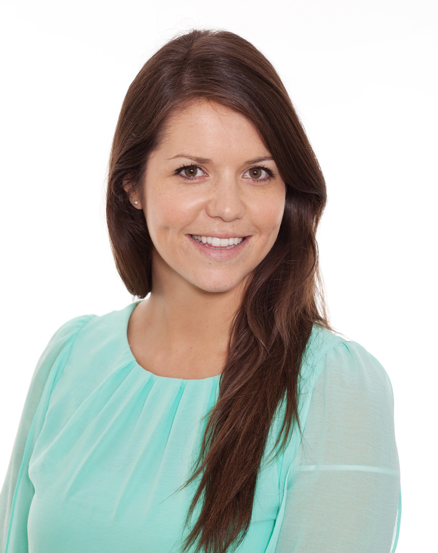Relaxed business headshot portrait female wearing a green top professional photography studio with a white background