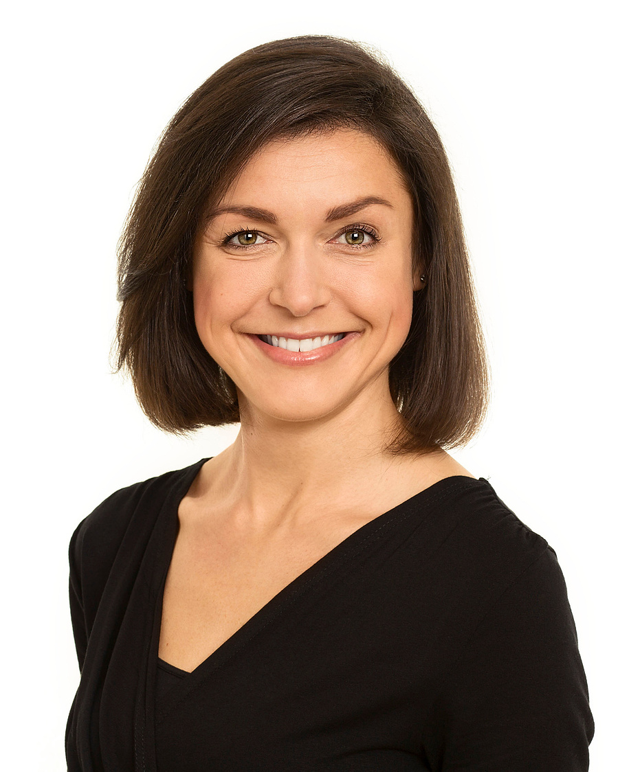 LinkedIn corporate headshot of young female  in professional photography studio white background