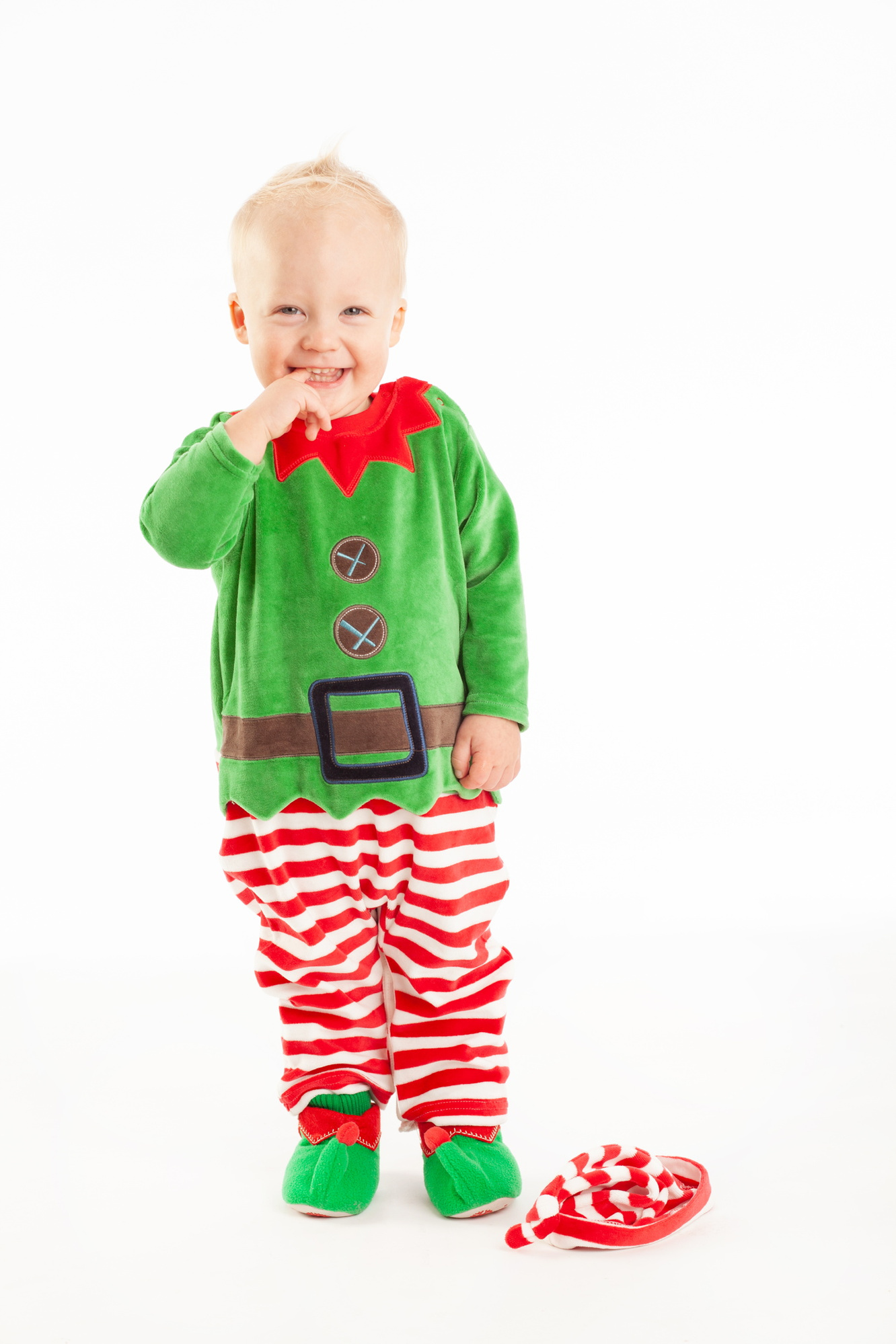 Christmas portrait of a little boy in elf costume in a professional family portrait photography studio with white background