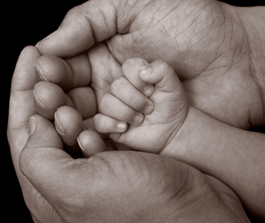 Close up photo of tiny newborn hand in parents hand family studio photography Christening Gift Voucher idea