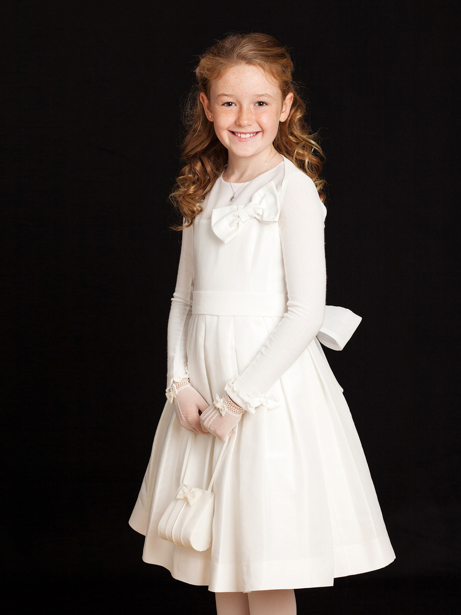 First Holy Communion Portrait of young girl taken in Professional Family Photography Studio with black background