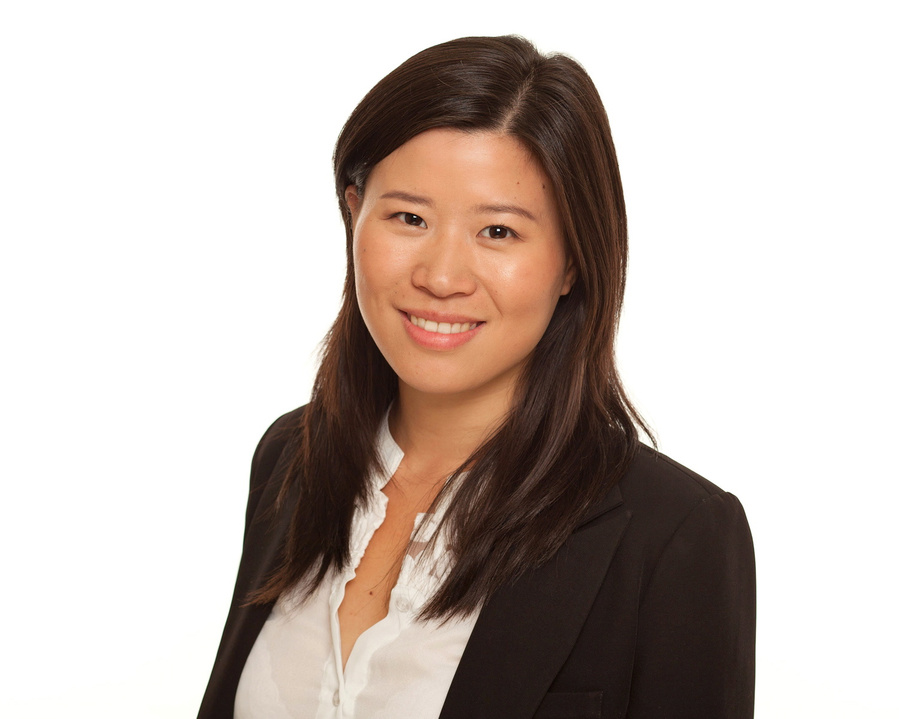 Natural smiling headshot of female business professional wearing a black jacket.  Photography studio portrait with white background for LinkedIn prolfile