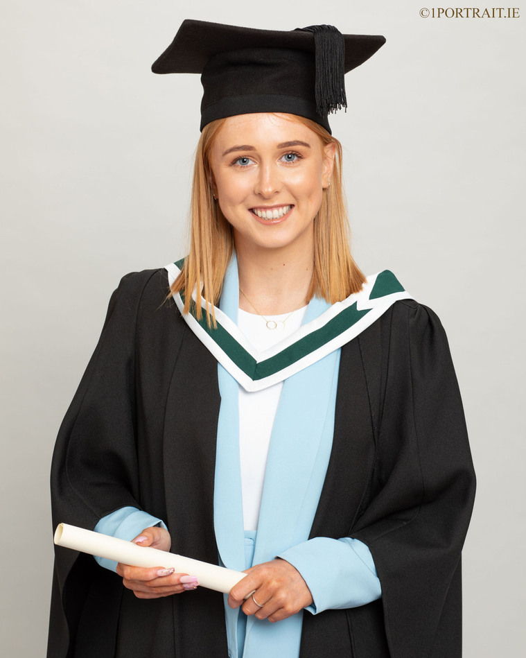 young female graduate student in professional photo studio graduation photographer dublin grey background