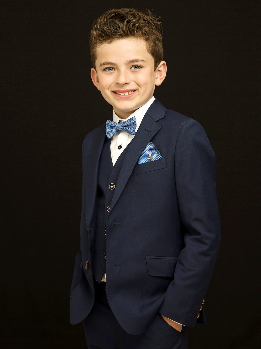First Holy Communion Portrait of young boy taken in Professional Family Photography Studio with black background