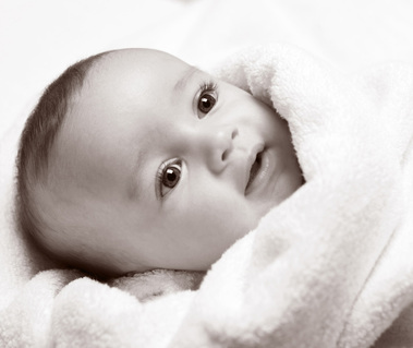 black and white close up of new baby in fluffy white towel Christening Gift Voucher idea