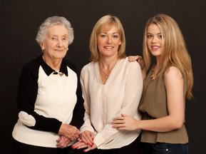 Generational portrait, grandmother, mother and daughter in professional photo studio dublin with black background