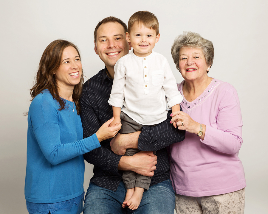 Grandmother, Father, mother and grandson in a generational portrait taken in a professional family photography studio in Dublin 