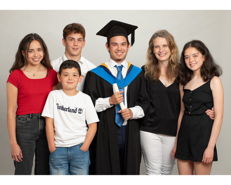 young male graduate student in a group family portrait taken in professional portrait photography studio graduation photographer Dublin