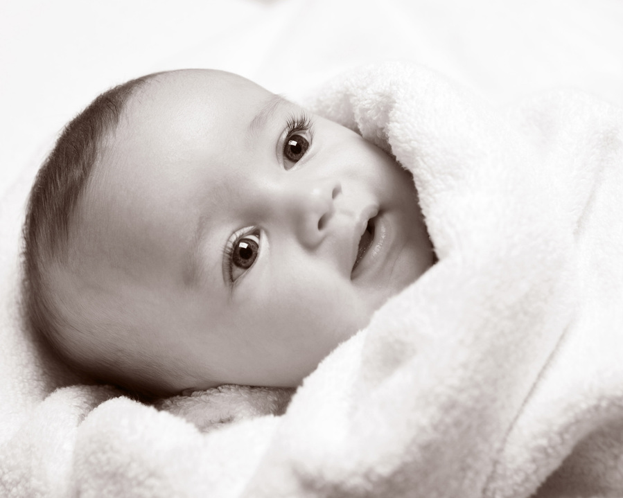 Classic black and white portrait of newborn baby swaddled in blanket professional family photography studio Dublin 