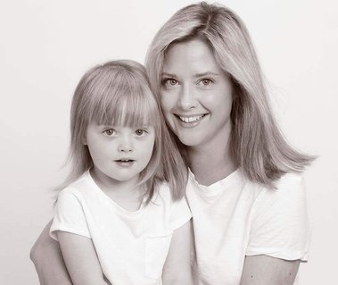 Close up portrait of mother and daughter wearing white in professional photography studio Dublin with white background