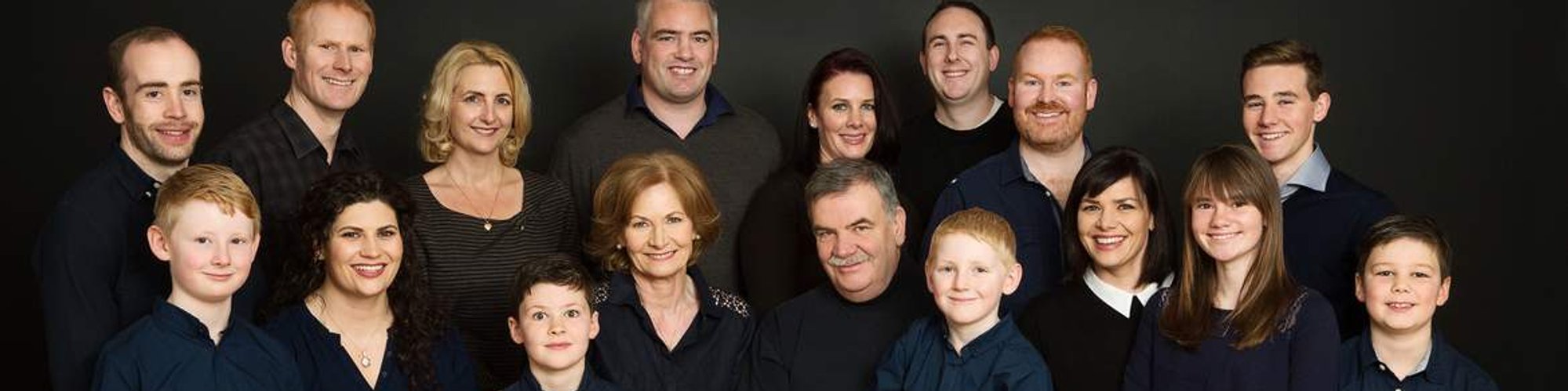 Large Group family photo in photography studio grandparents with grandchildren wedding anniversary gift