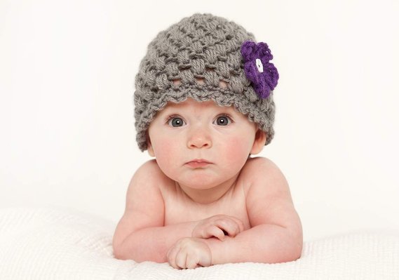 Head and shoulders portrait of a young baby in professional family photography studio in Dublin white background