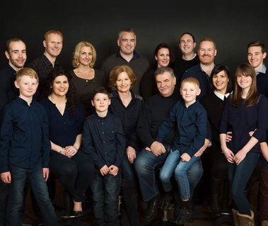 Large Group family photo in photography studio grandparents with grandchildren wedding anniversary gift