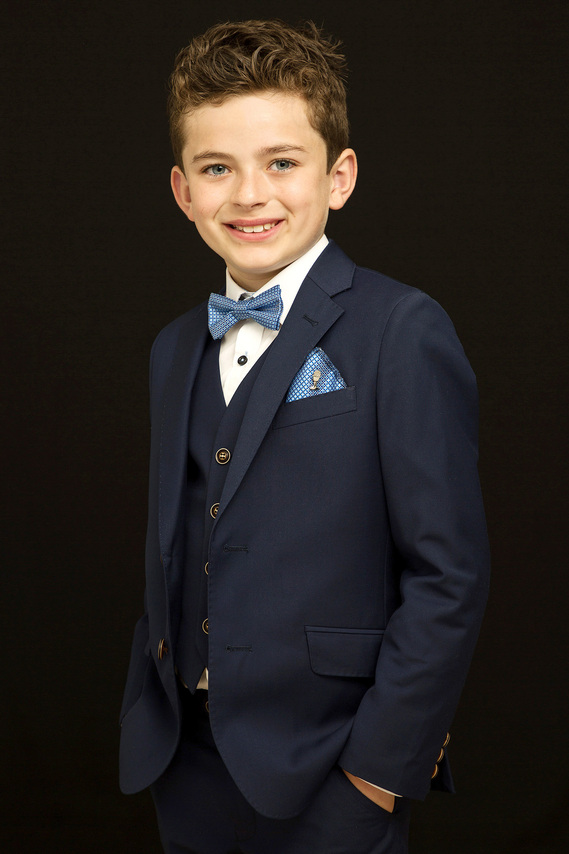 First Holy Communion Portrait of young boy taken in Professional Family Photography Studio with black background