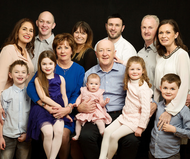 Group family photo in photography studio grandparents with grandchildren wedding anniversary gift