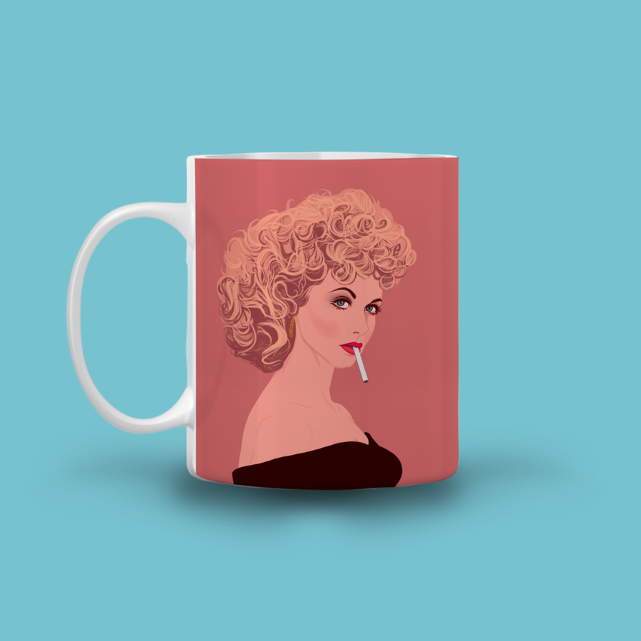 Olivia Newton-John as Sandra Olsson in the hit musical comedy  Grease.  The 11oz ceramic mug features artwork by Ryan Hodge illustration featuring Sandy and the phrase "Tell me about it stud (over a cuppa)"