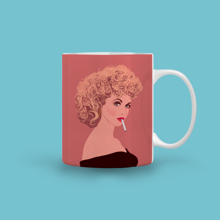 Olivia Newton-John as Sandra Olsson in the hit musical comedy  Grease.  The 11oz ceramic mug features artwork by Ryan Hodge illustration featuring Sandy and the phrase "Tell me about it stud (over a cuppa)"