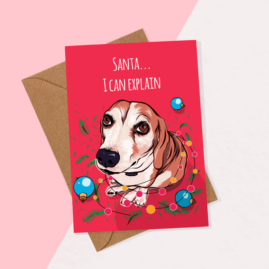 Dog Christmas card featuring beagle tangled in fairy lights on red background.  Comes with brown envelope.  Available individually and as a multipack.  Artwork by Ryan Hodge illustration / Woof Portraits