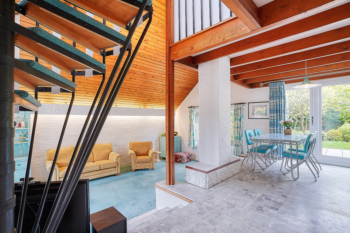 A beautiful 1960s detected chalet styled property with many original features still intact including a lovely spiral staircase which provides a very strong leading edge to this image.