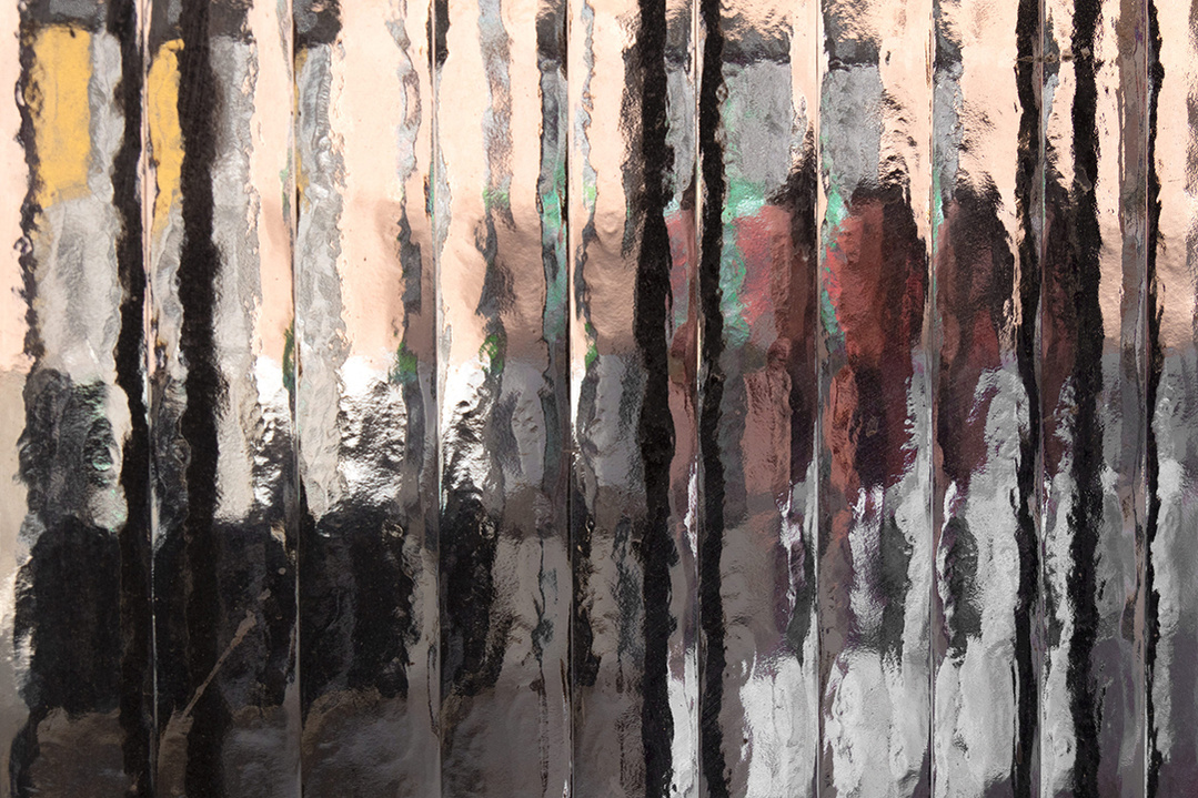 Street level photograph of pedestrians on a Madrid street through a distorting window