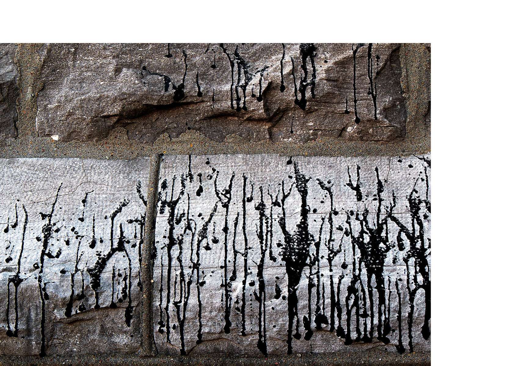 Dripped black paint resembling a landscape