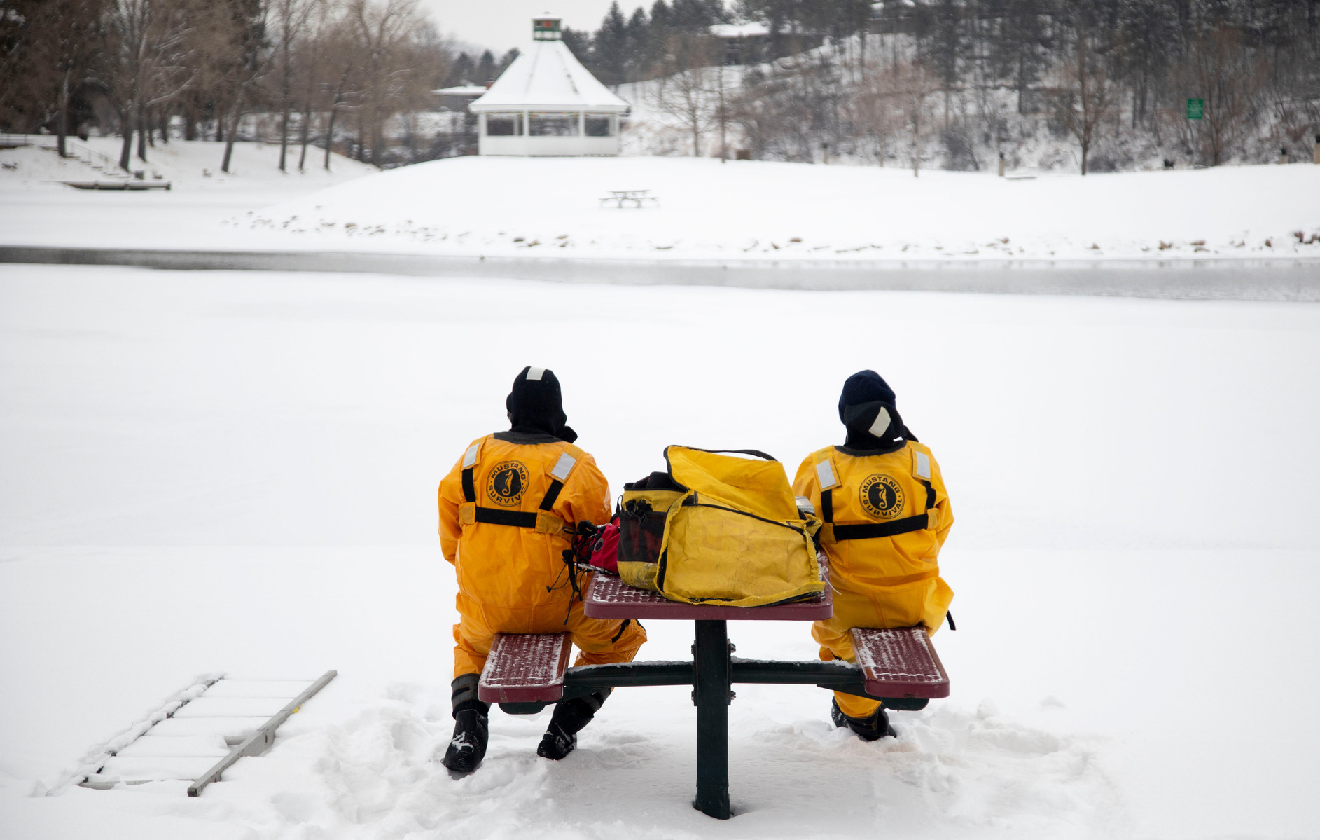 Firefighters Lon Chau (right) and Tanner Urbaniak wait to begin ice training as they look out over Canyon Lake on Wednesday, Feb. 17, 2021, in Rapid City, S.D.