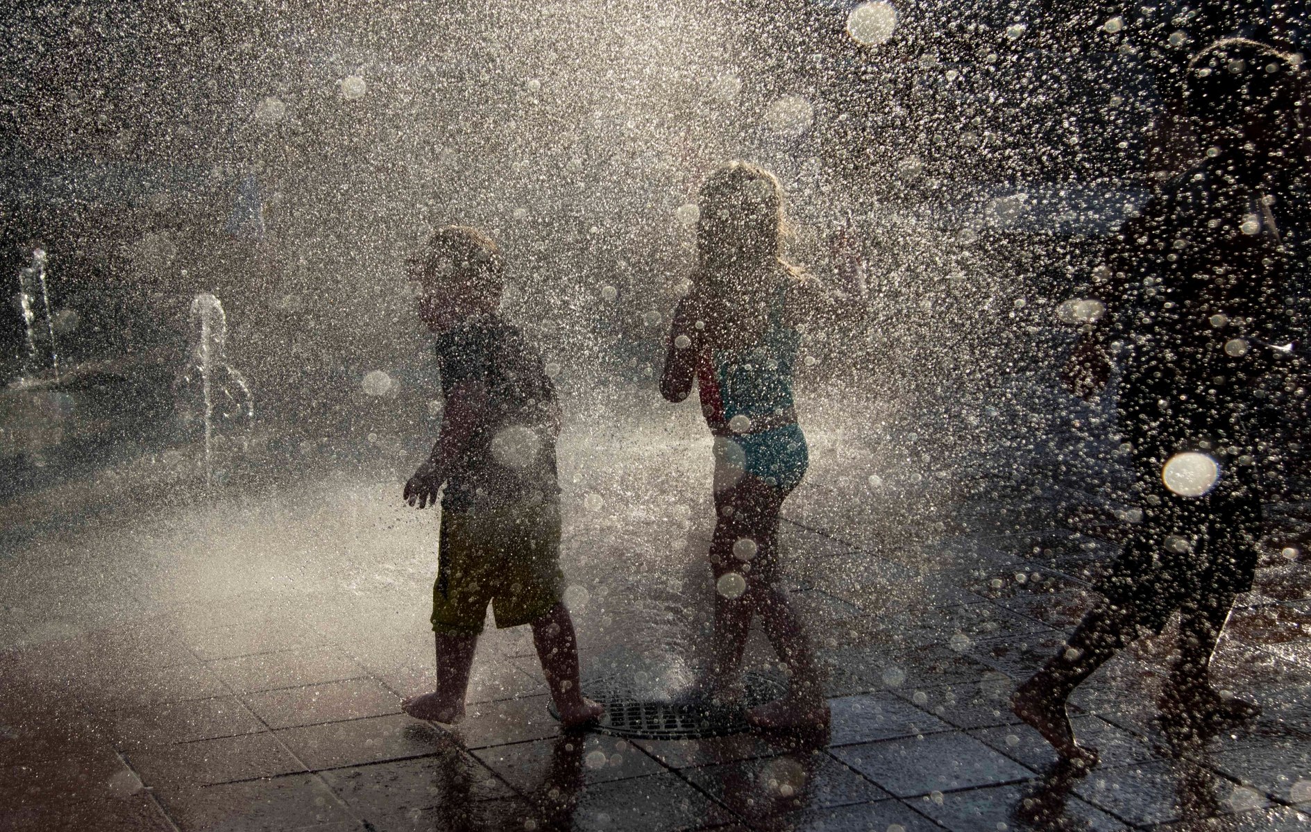 Children play in fountains at Main Street Square on Thursday, June 10, 2021, in Rapid City, S.D.