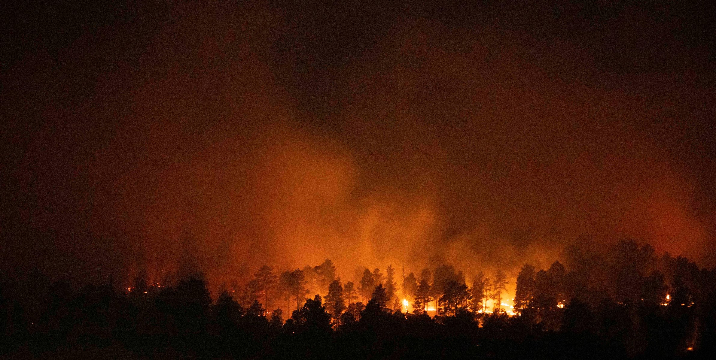 Wildfires continue to burn early Tuesday on March 30, 2021, in Rapid City, S.D. The Schroeder Fire broke out at about 9 a.m. on Monday morning.
