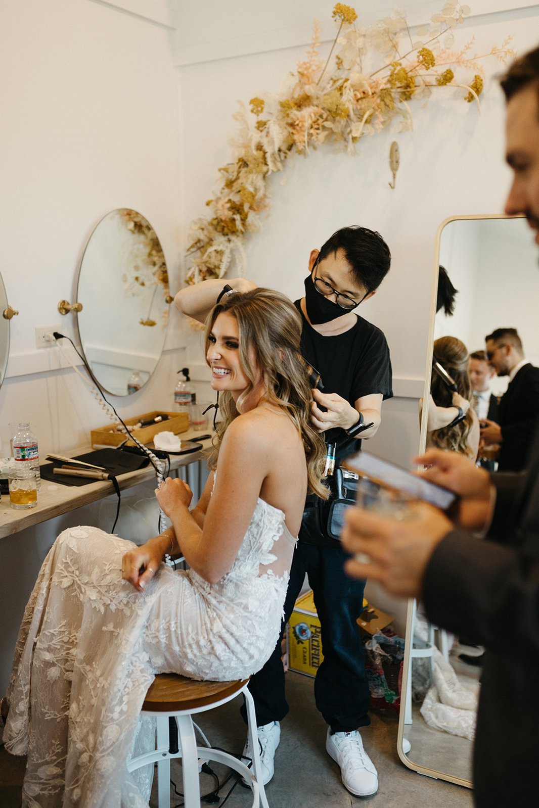 Asian wedding hairstylist working on gorgeous bride's hair.