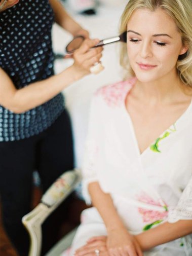 Blond hair bride having her makeup done, very natural and clean beauty wedding makeup.